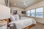 1st Guest Bedroom- Queen bedroom with en suite, TV, and private deck